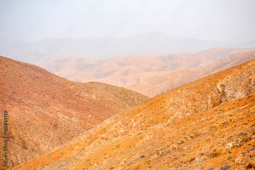 Mountain landscape at the central part of Fuerteventura island on the cloudy and foggy weather in Sp