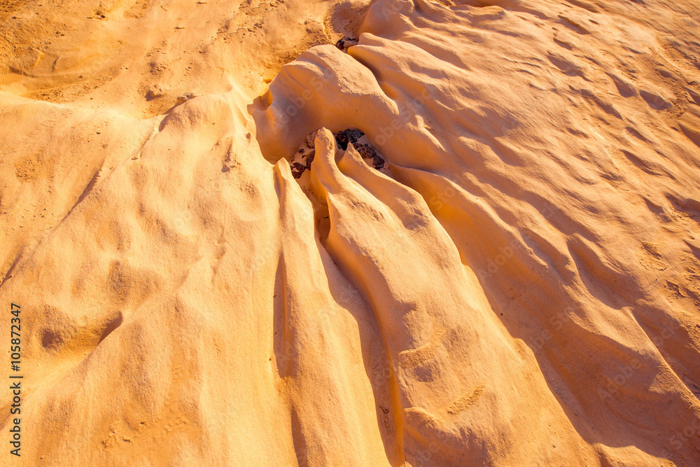 Dried riverbed with beautiful solid sand shapes on Fuerteventura island in Spain. Abstract backgroun