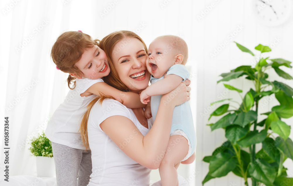 happy family mother and two children, son and daughter in bed