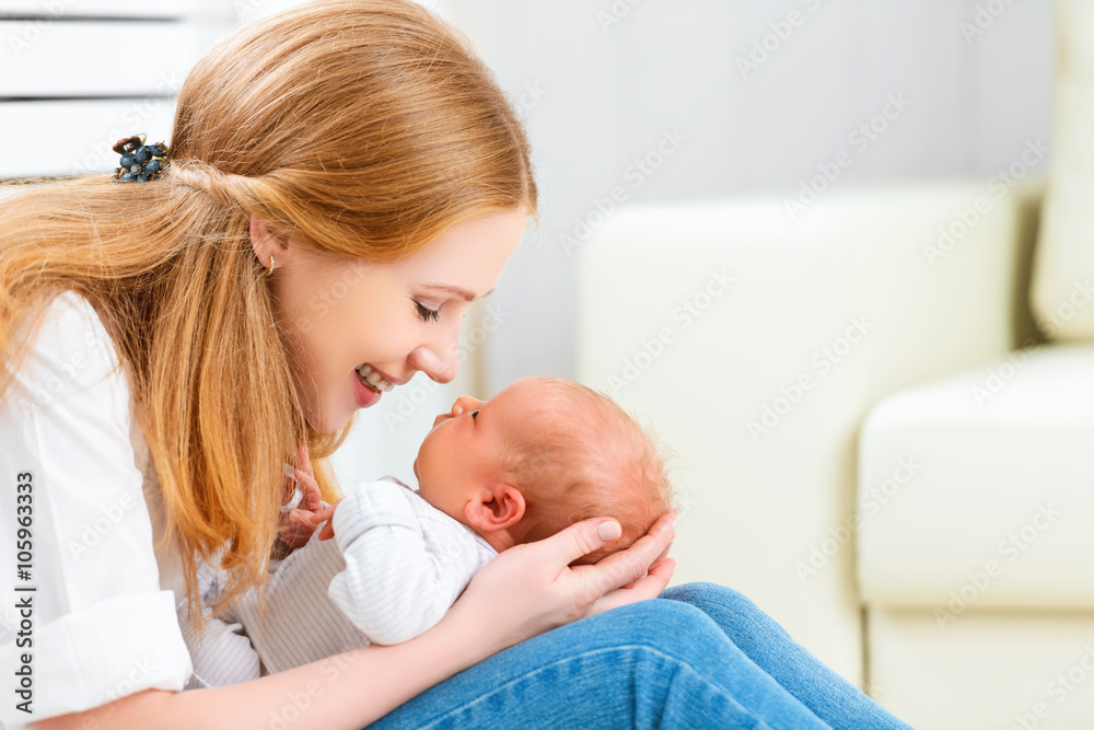 happy family. mother plays with newborn baby