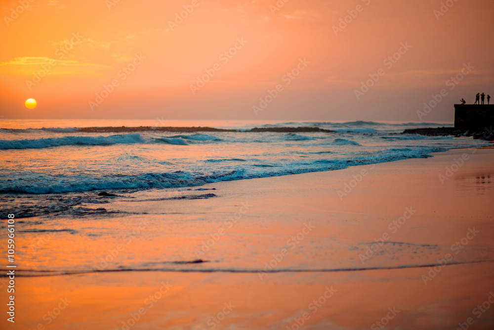 Beach with glossy surface reflecting beautiful seascape on the sunset in Maspalomas on Gran Canaria 