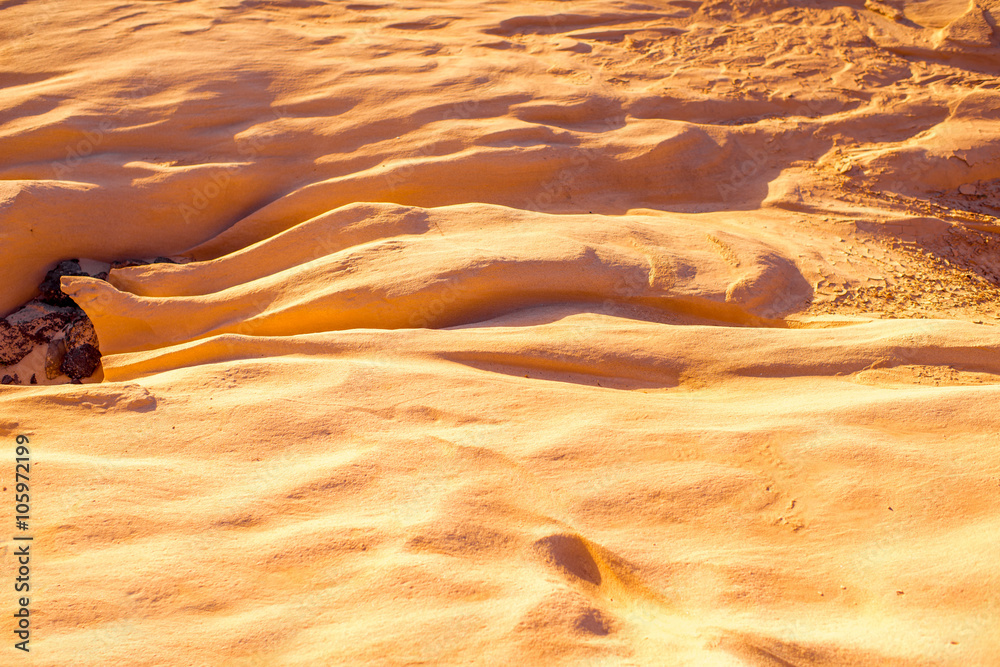 Dried riverbed with beautiful solid sand shapes on Fuerteventura island in Spain. Abstract backgroun