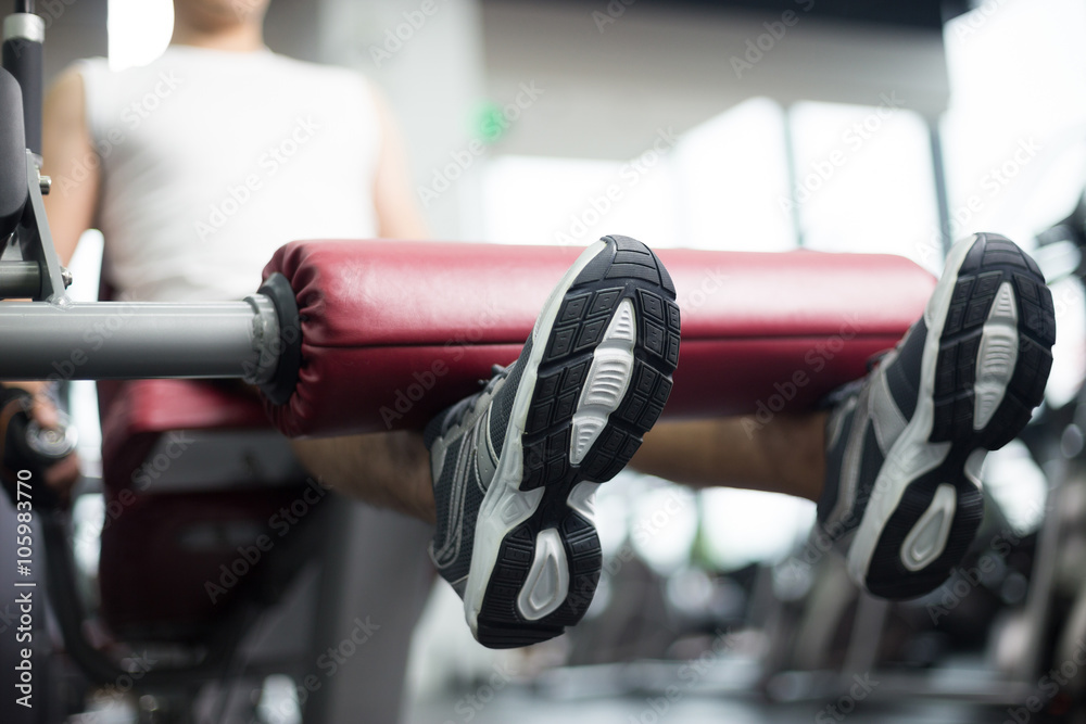 young handsome man works out in modern gym