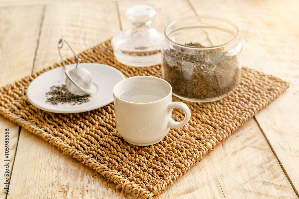 Tea set on the wooden table at sunny morning