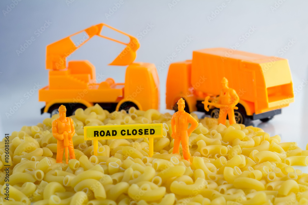 uncooked pasta and set of workmen on a white background