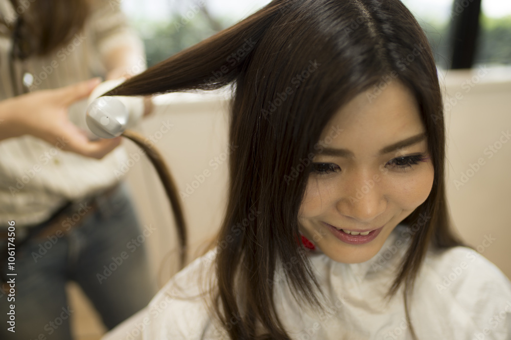 Hairdresser curled the hair of women