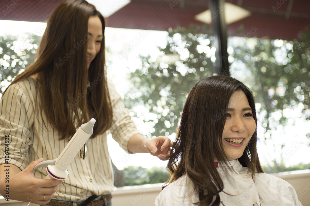 Hairdresser curled the hair of women