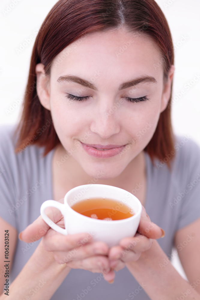 woman holding cup of  tea