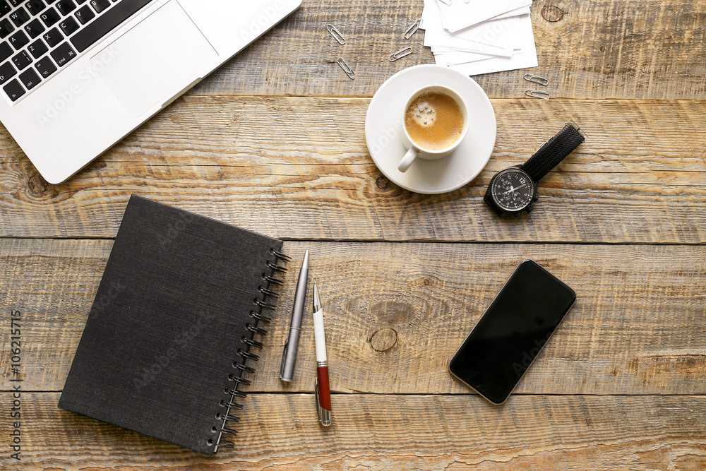 Working place with notebook on wooden table