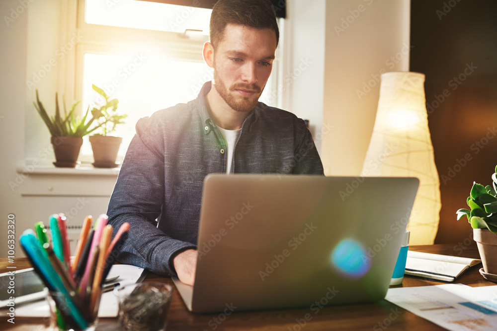 Worried businessman reading data on his laptop