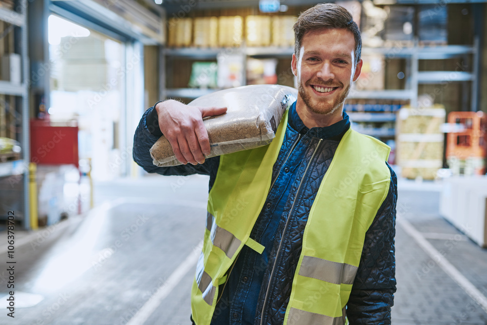 Smiling young man working in a warehouse