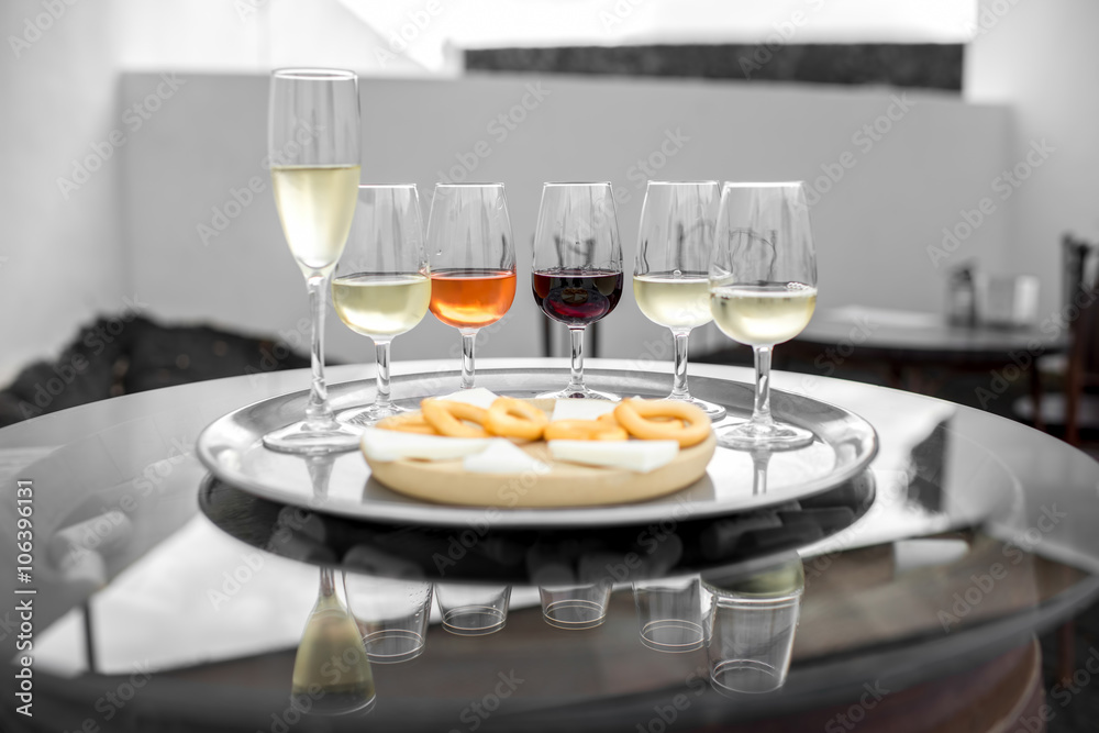 Set of six different wines in wineglasses with snack on the table for degustation