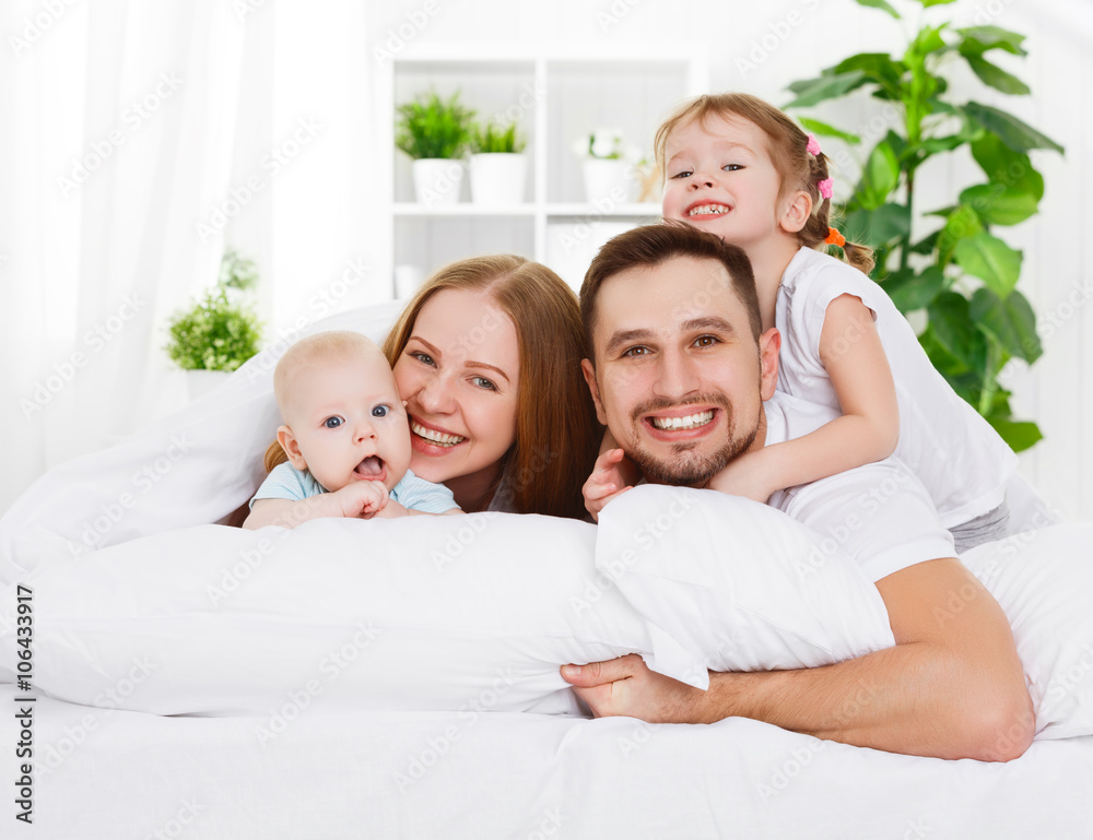 happy family at home in  the bed