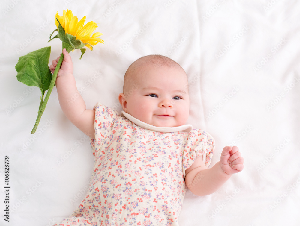 Newborn baby girl lying on her blanket