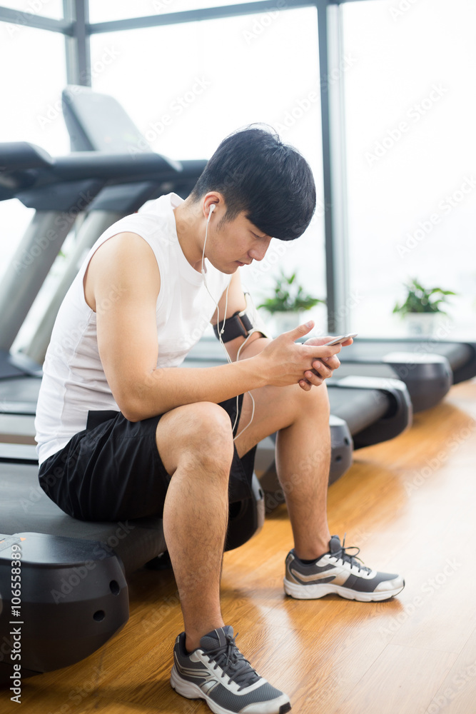 young handsome asian man works out in modern gym