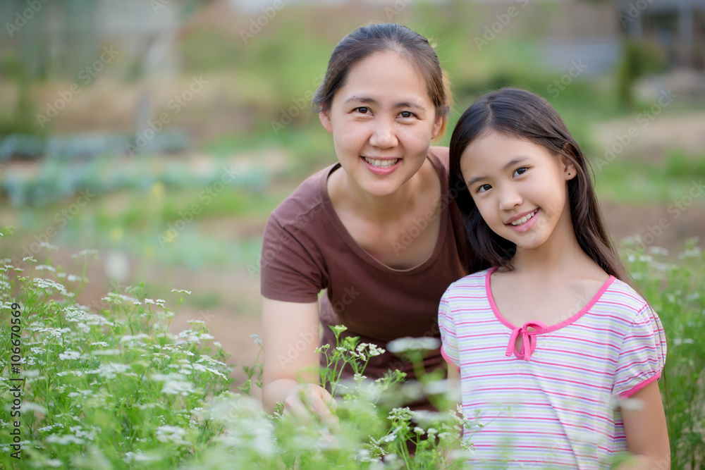 Happy Asian daughter gardening with her mother