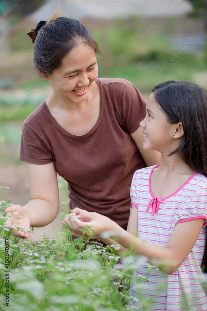 Happy Asian daughter gardening with her mother