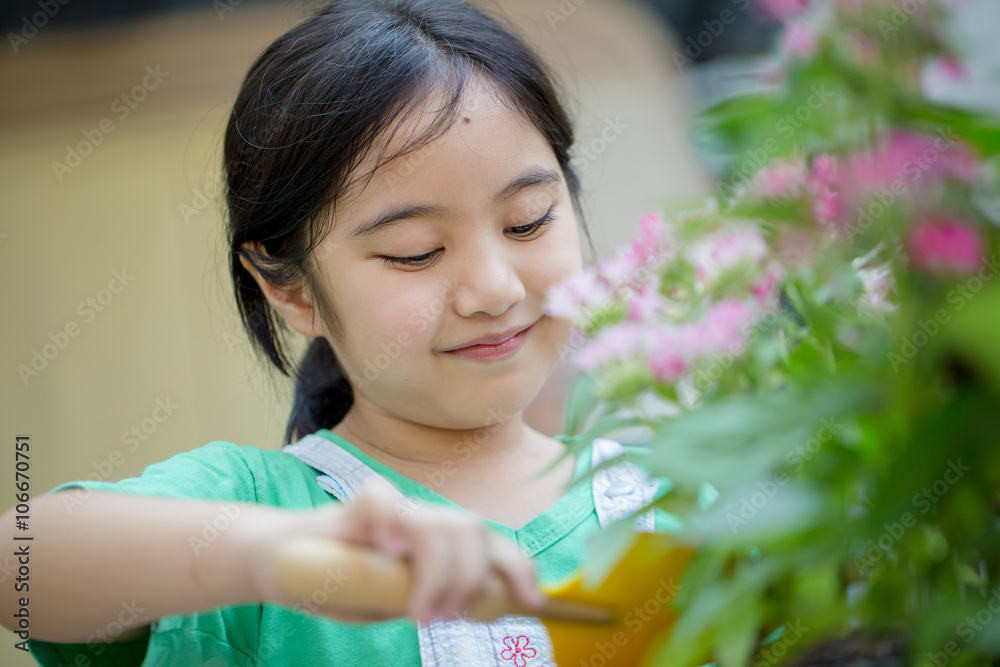 Little Asian child planting flower