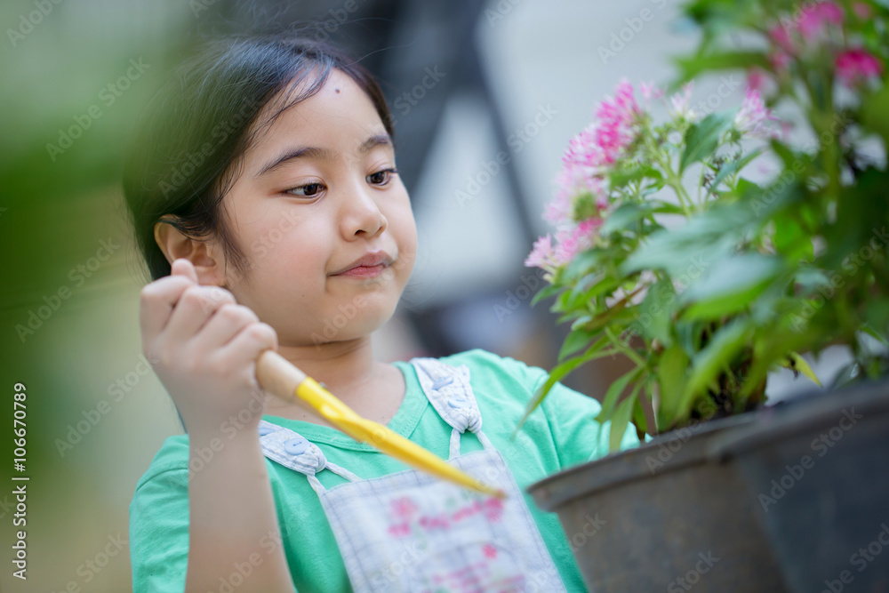 Little Asian child planting flower