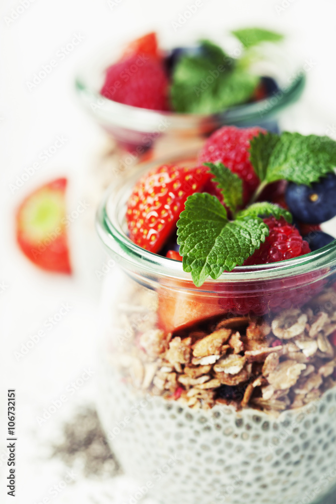 Chia seeds vanilla pudding and berries on wooden rustic backgrou