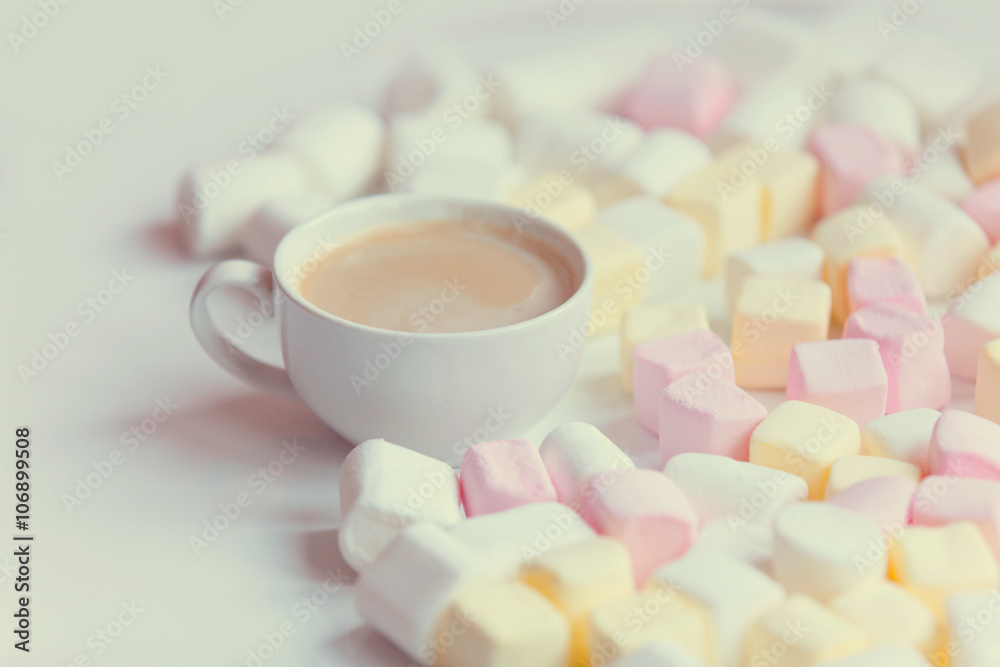 marshmallow and cup of coffee on the table