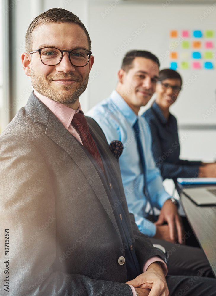 Handsome man with two co-workers at table