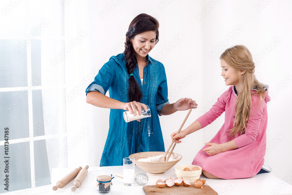 Happy mother and daughter baking