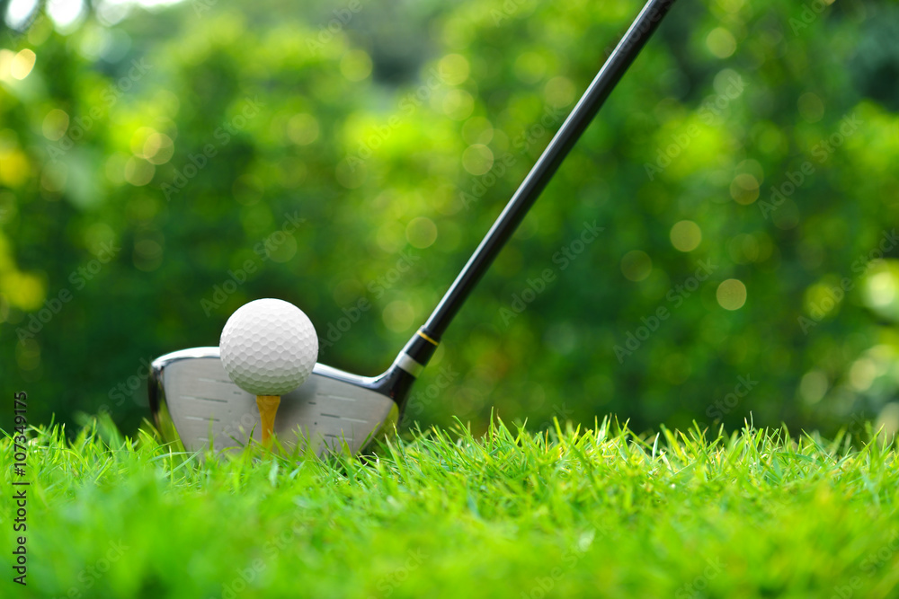 Golf ball on green grass ready to be struck on golf course background