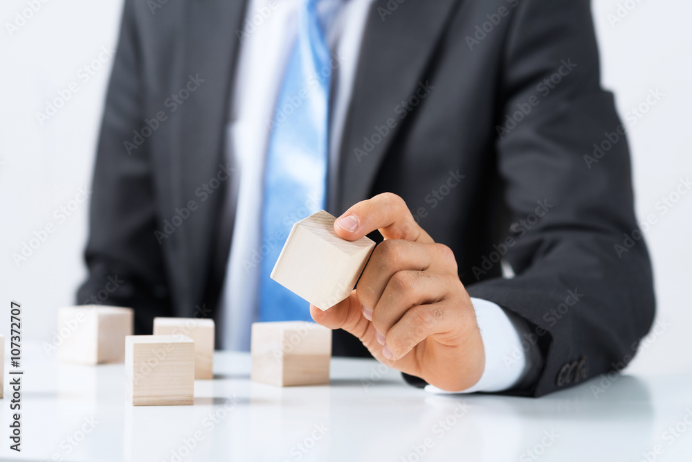 Businessman making tower