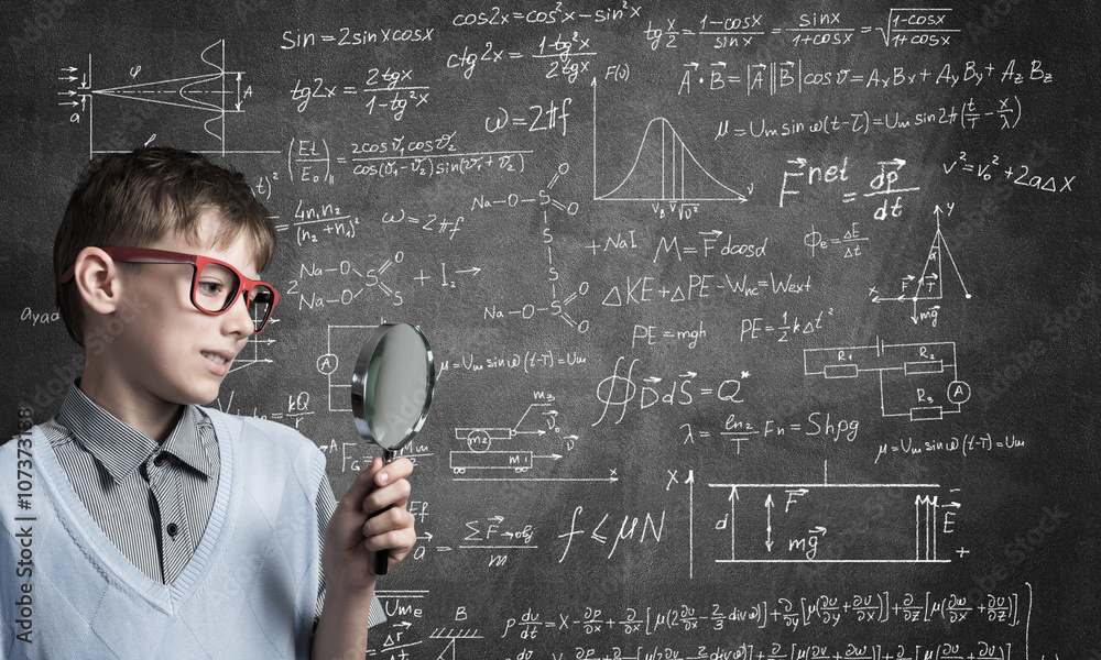 Curious school boy with magnifier