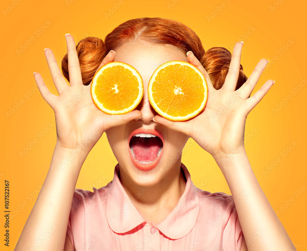 Beauty model girl takes juicy oranges