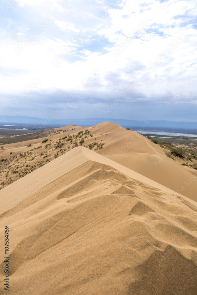 view from the dune brink on prairie and mountains