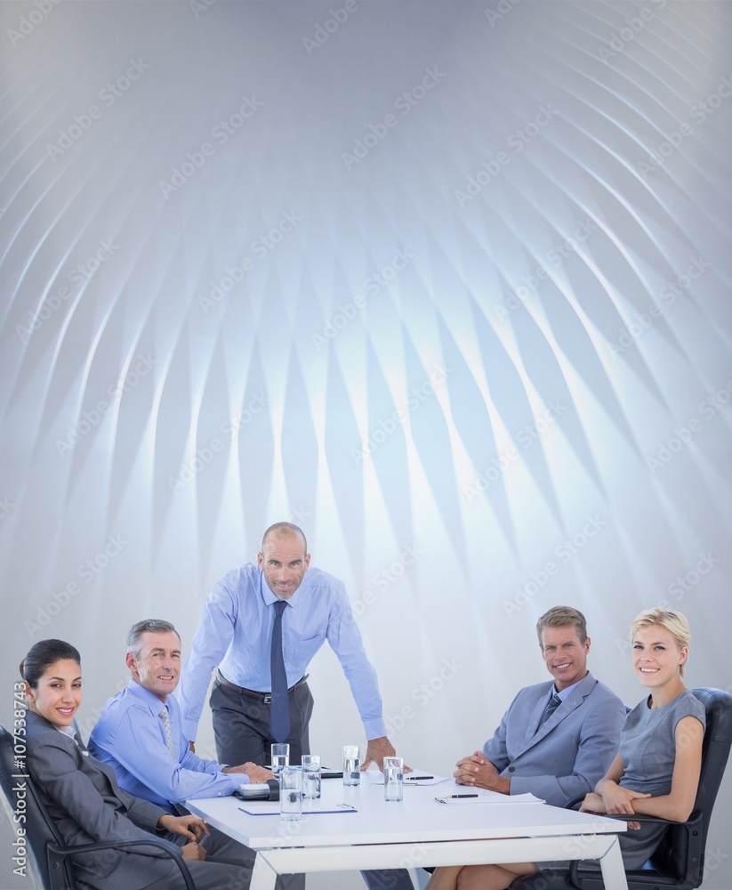 Composite image of happy business people looking at camera