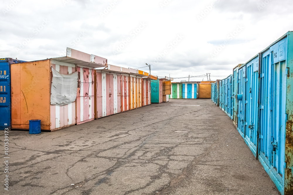 multicolored garages in the industrial area witn asphalt road