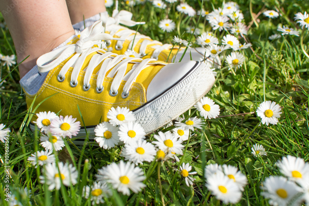 Yellow sneakers decorated with daisies