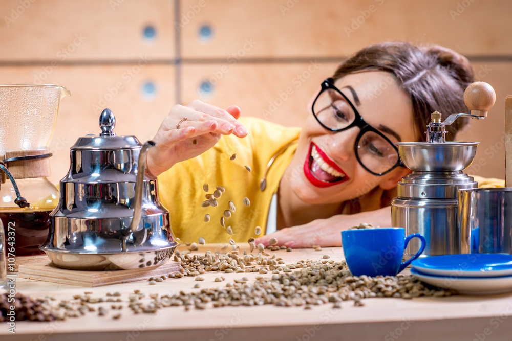 Close-up portrait of a young smiling woman on the wooden table full of various stuff for alternative