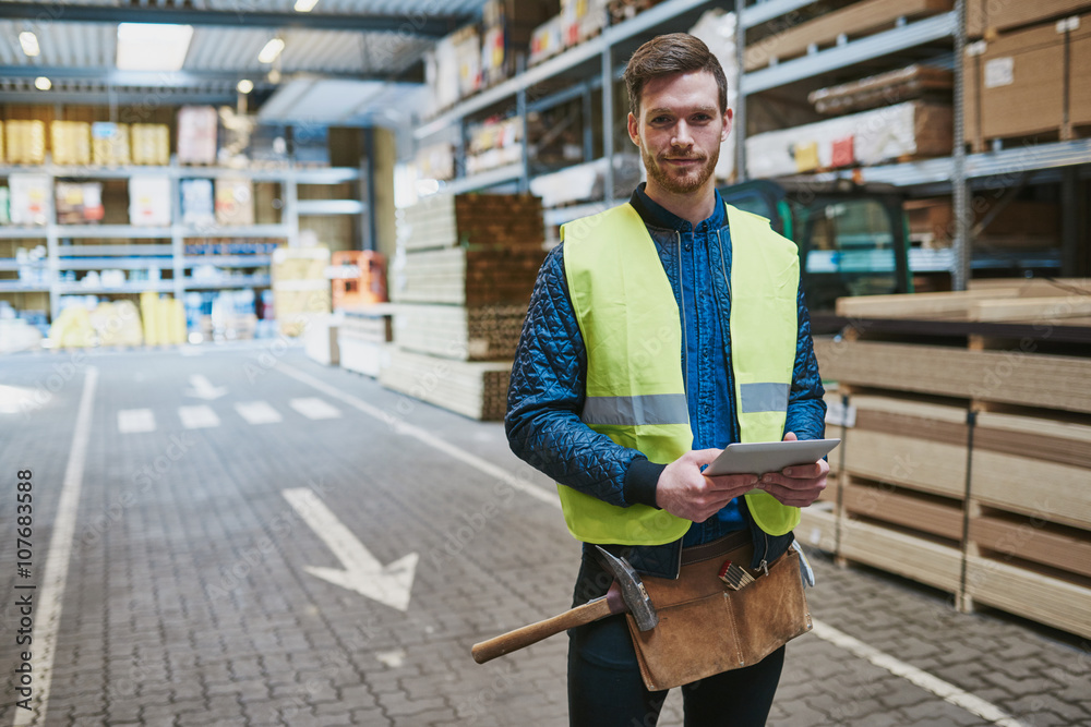 Handsome young handyman in a warehouse