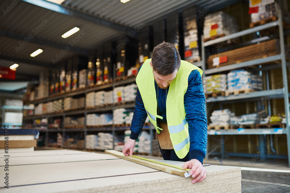 Young handyman working in a warehouse