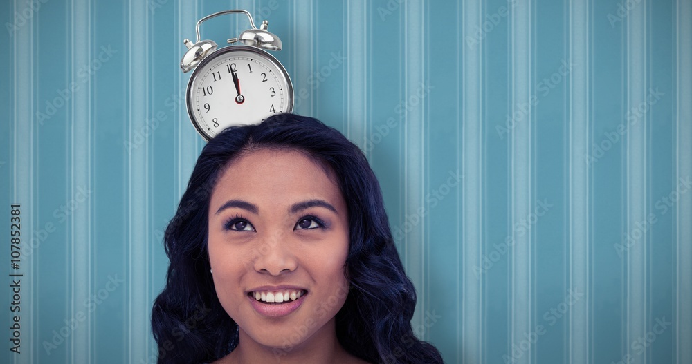 Composite image of smiling asian woman with paper crown