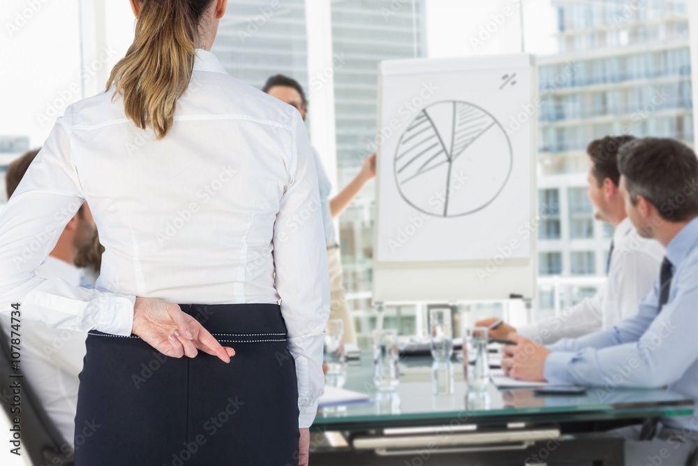 Composite image of rear view of businesswoman finger crossed