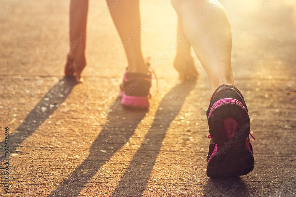 woman ready to start running on track in the morning, warm color tone