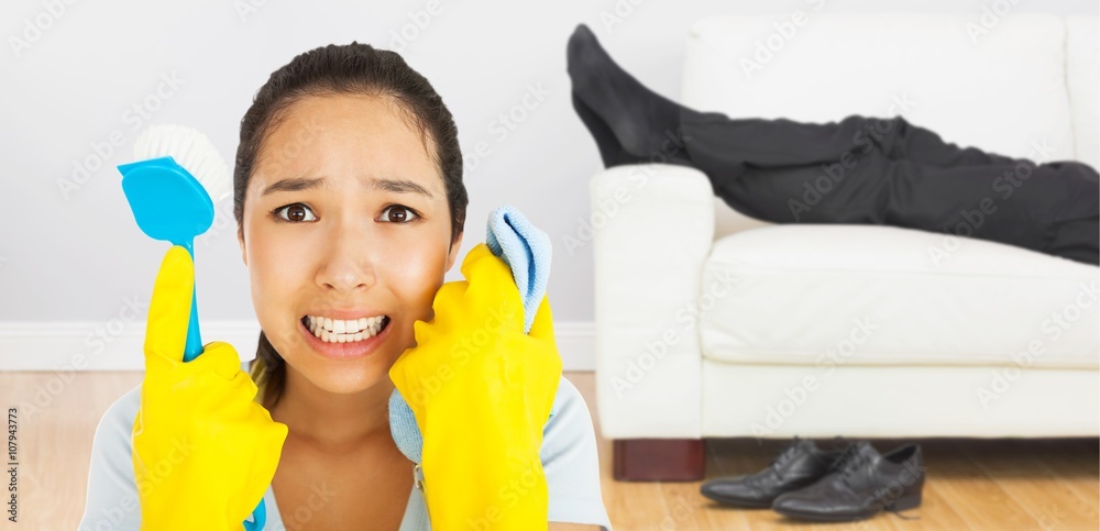 Composite image of distressed woman holding cloth