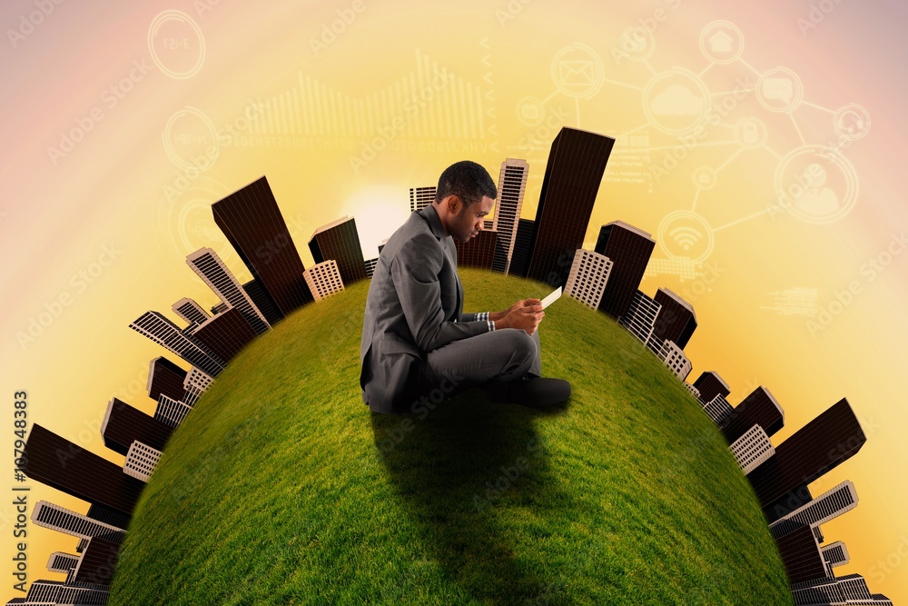 Composite image of businessman sitting and holding tablet