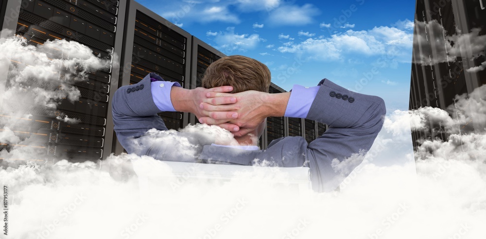 Composite image of relaxed businessman extended on a chair