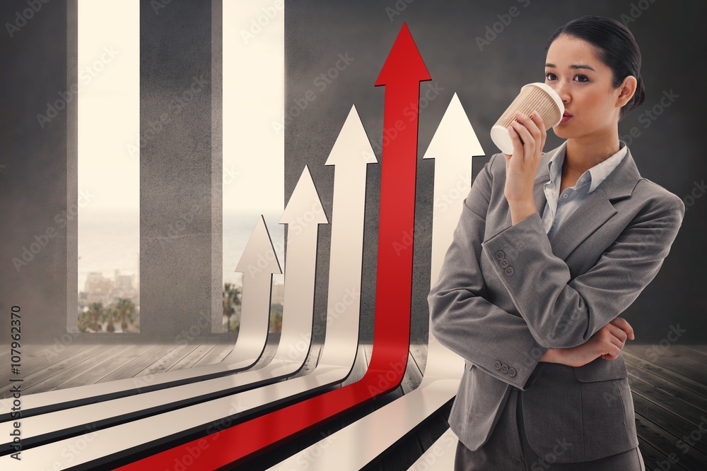 Composite image of portrait of a businesswoman drinking 