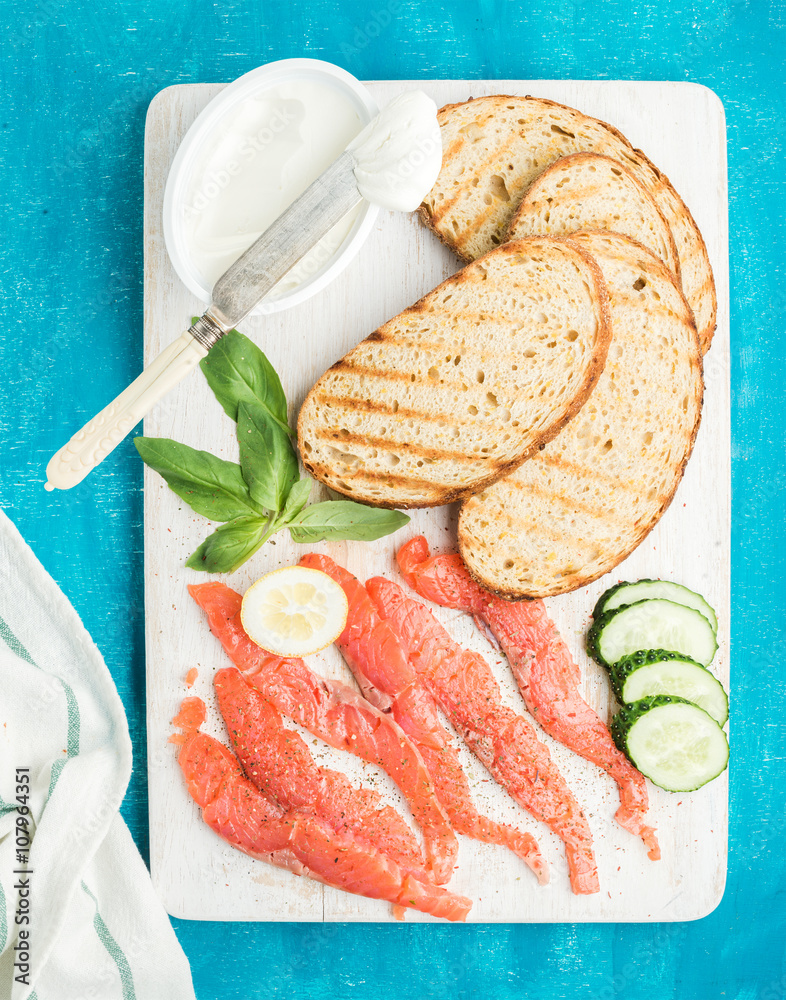 Ingredients for healthy sandwich. Grilled bread slices, smoked salmon, cottage cheese, cucumber and 