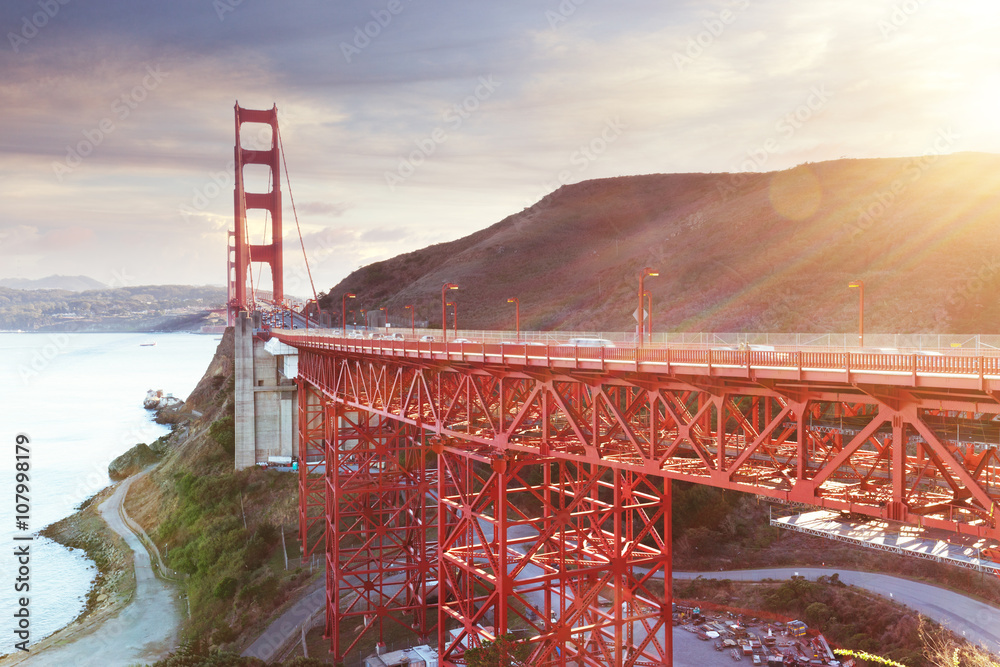 closeup of structure of gold gate bridge at sunrise