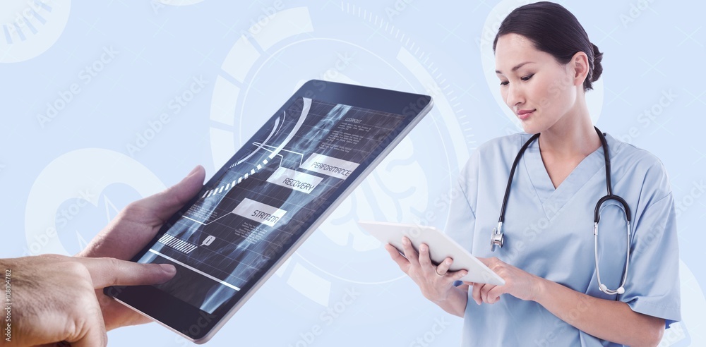 Composite image of surgeon using digital tablet with group