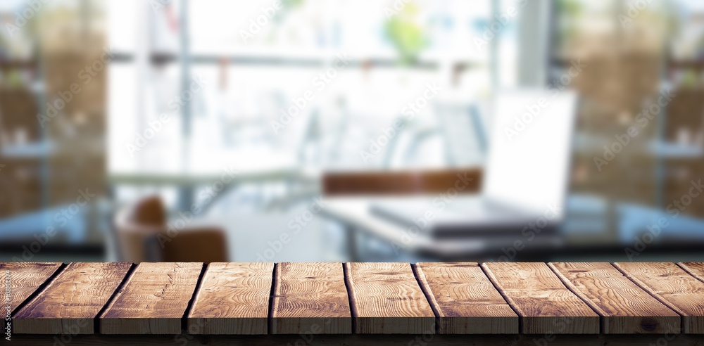 Composite image of laptop on a table