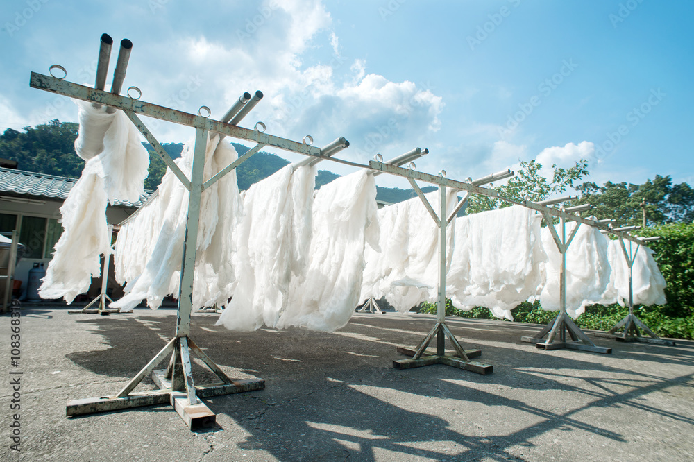 silk quilt is showed in a clothes drying field